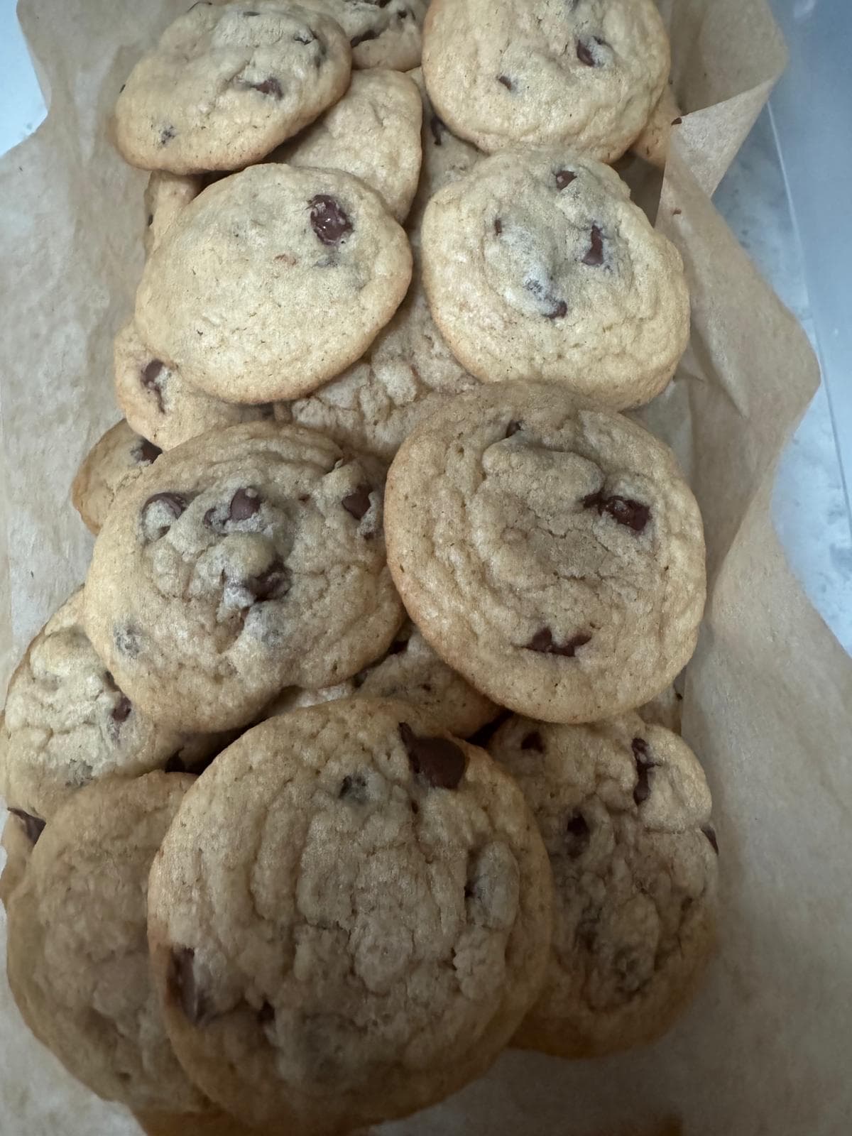 Chocolate chip cookies in a parchment-lined box